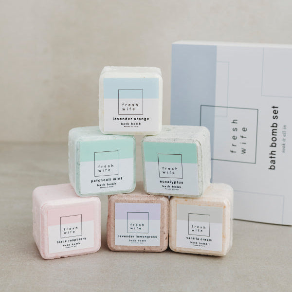 Box of bath bombs with 'fresh wife' branding on a neutral background