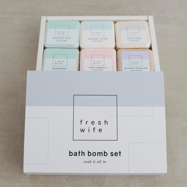 Box of bath bombs with 'fresh wife' branding on a neutral background